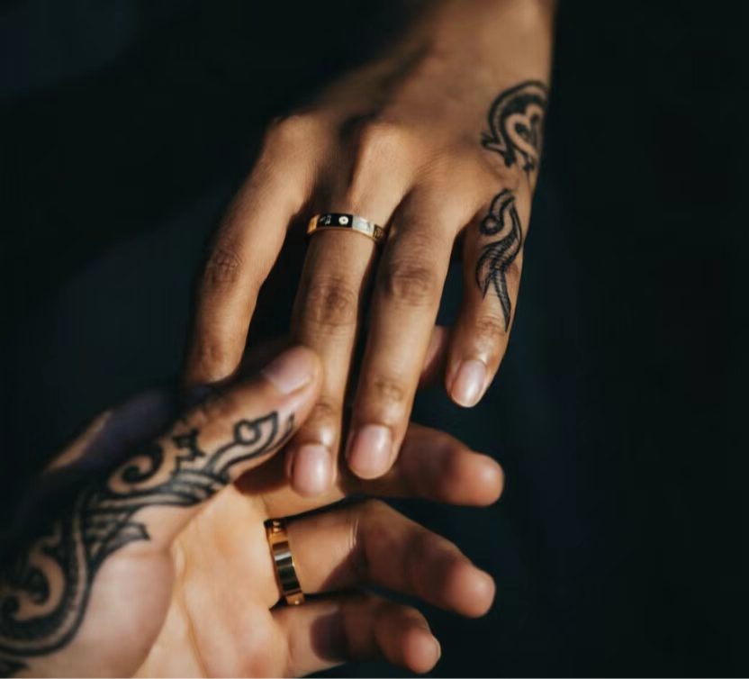 Roman Numeral Couple's Band on couple's hands